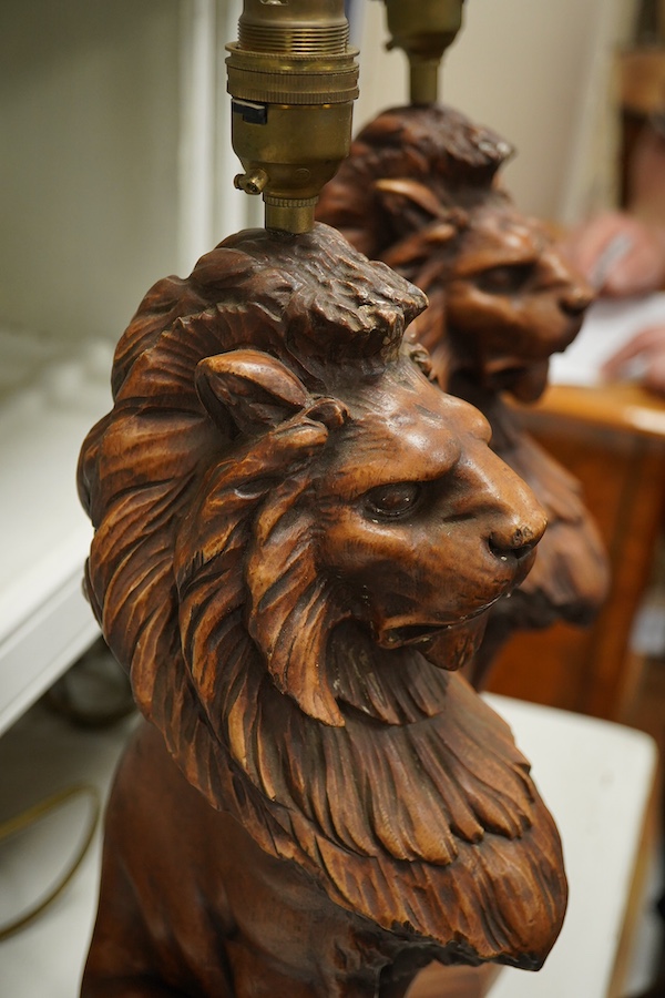 A pair of Thomas Blakemore faux oak 'lion' lamp bases, 47cm high overall. Condition - some minor chips